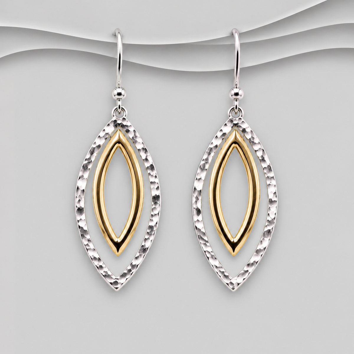 Two-tone marquise drop earrings with hammered sterling silver outer frames, polished gold-tone inner details and silver hook fittings