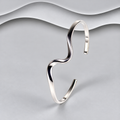 Polished 925 sterling silver open cuff bangle with flowing S-shaped wave curves