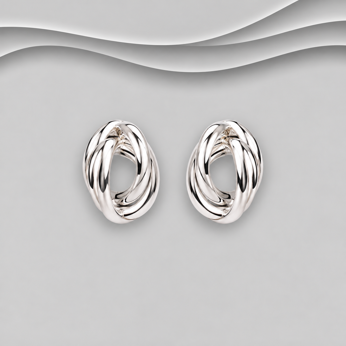 925 sterling silver interwoven knot stud earrings with polished overlapping silver loops and an oval shape