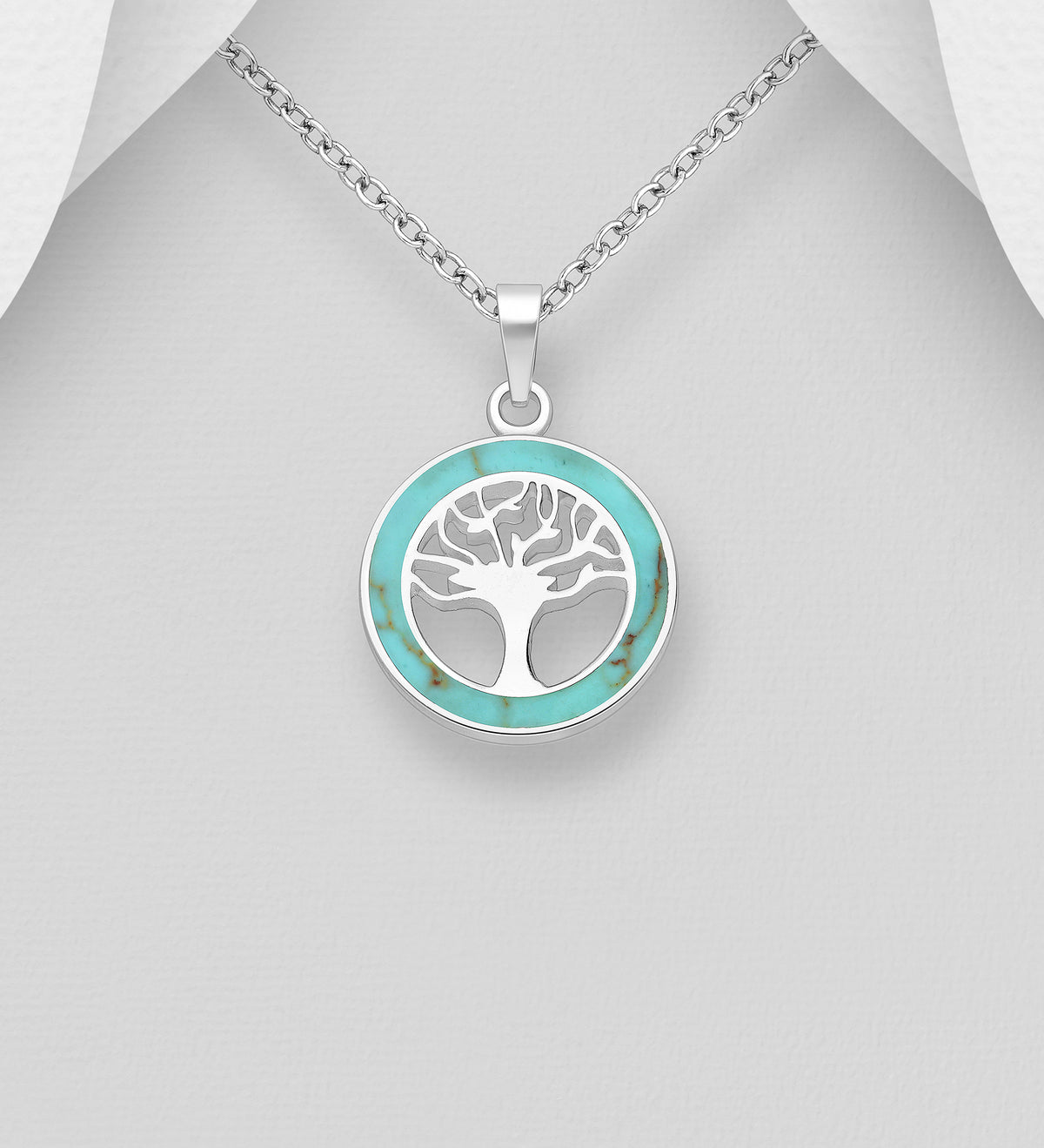 Round sterling silver openwork Tree of Life pendant with a turquoise resin border, shown on a chain
