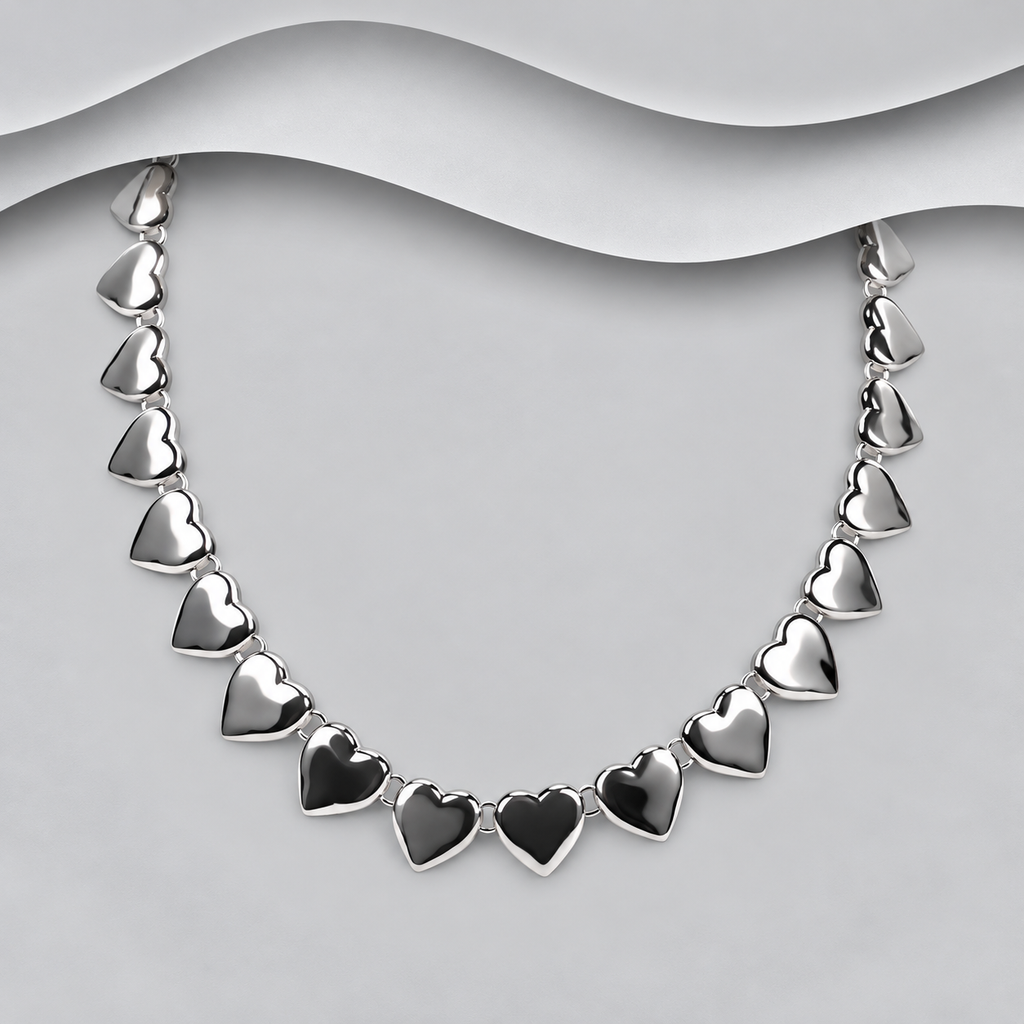 925 sterling silver necklace with individually linked polished hearts on a light grey bust