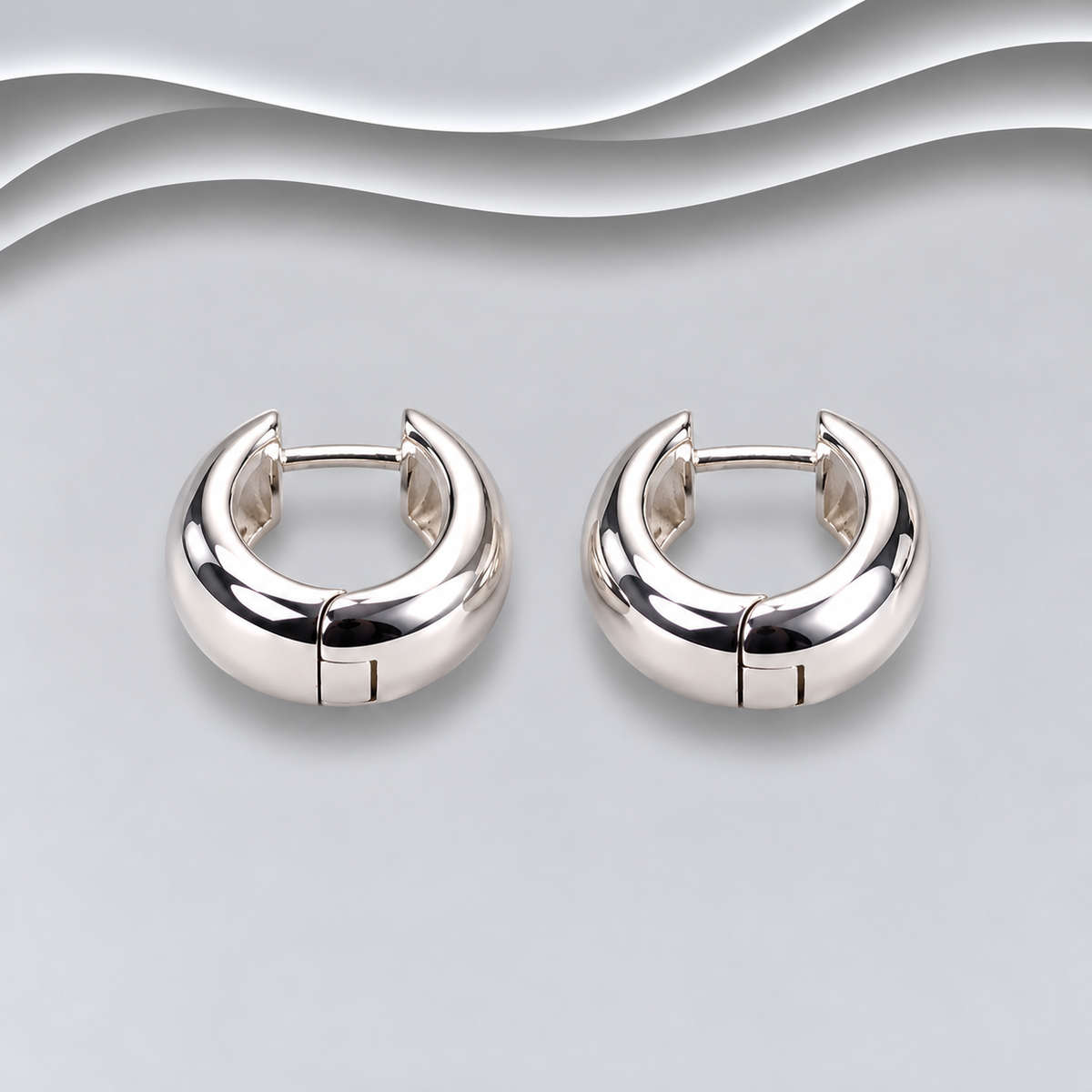 Pair of polished 925 sterling silver chunky huggie hoop earrings with hinged fastenings