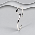 Polished sterling silver open cuff bangle with a sculptural wave design