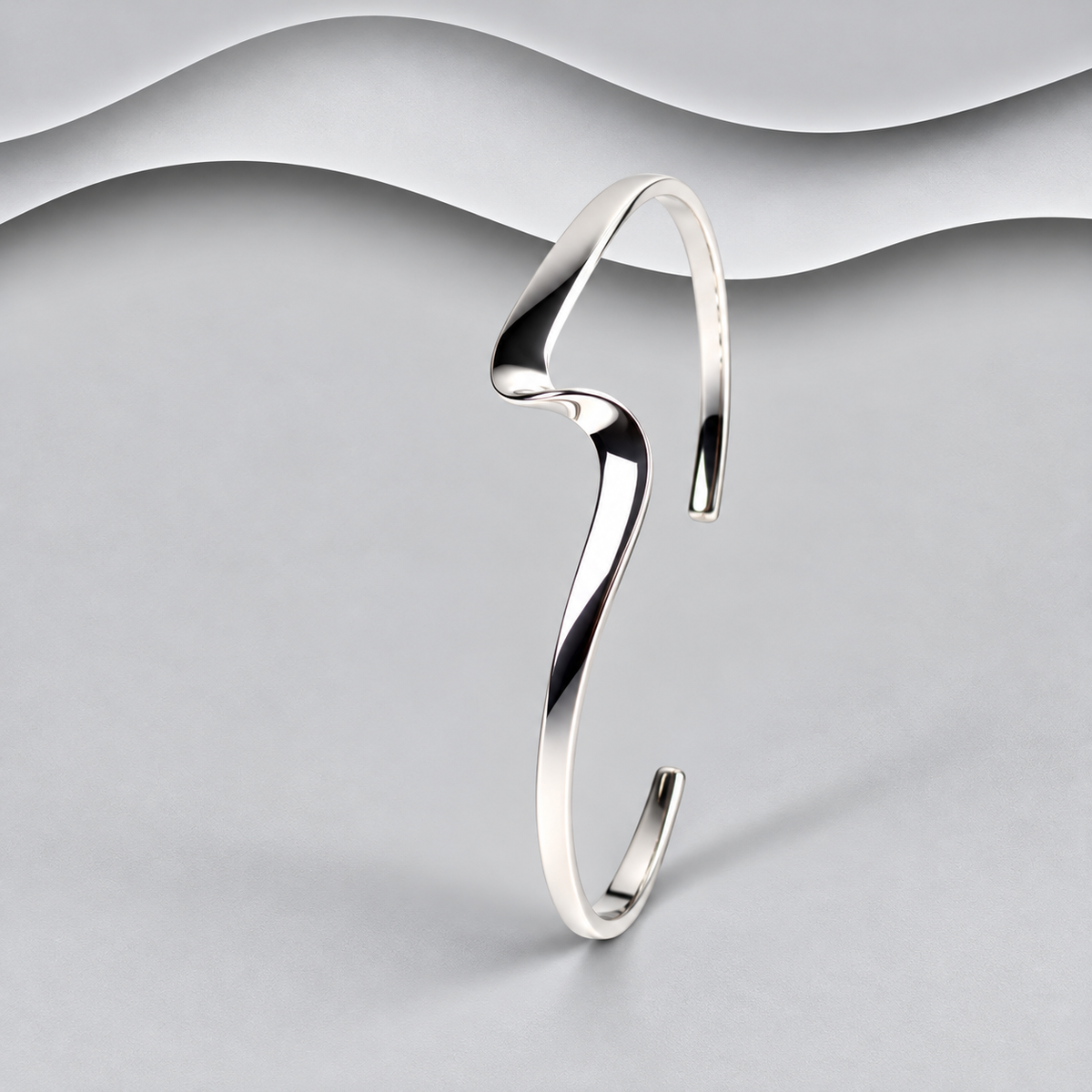 Polished sterling silver open cuff bangle with a sculptural wave design